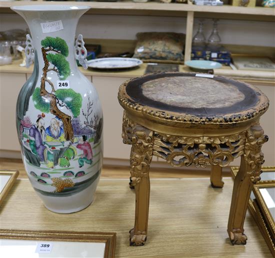 A large Chinese famille rose vase and gilt hardwood stand